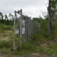 Photo of the fence around the landfill area of Dot Lake Village.